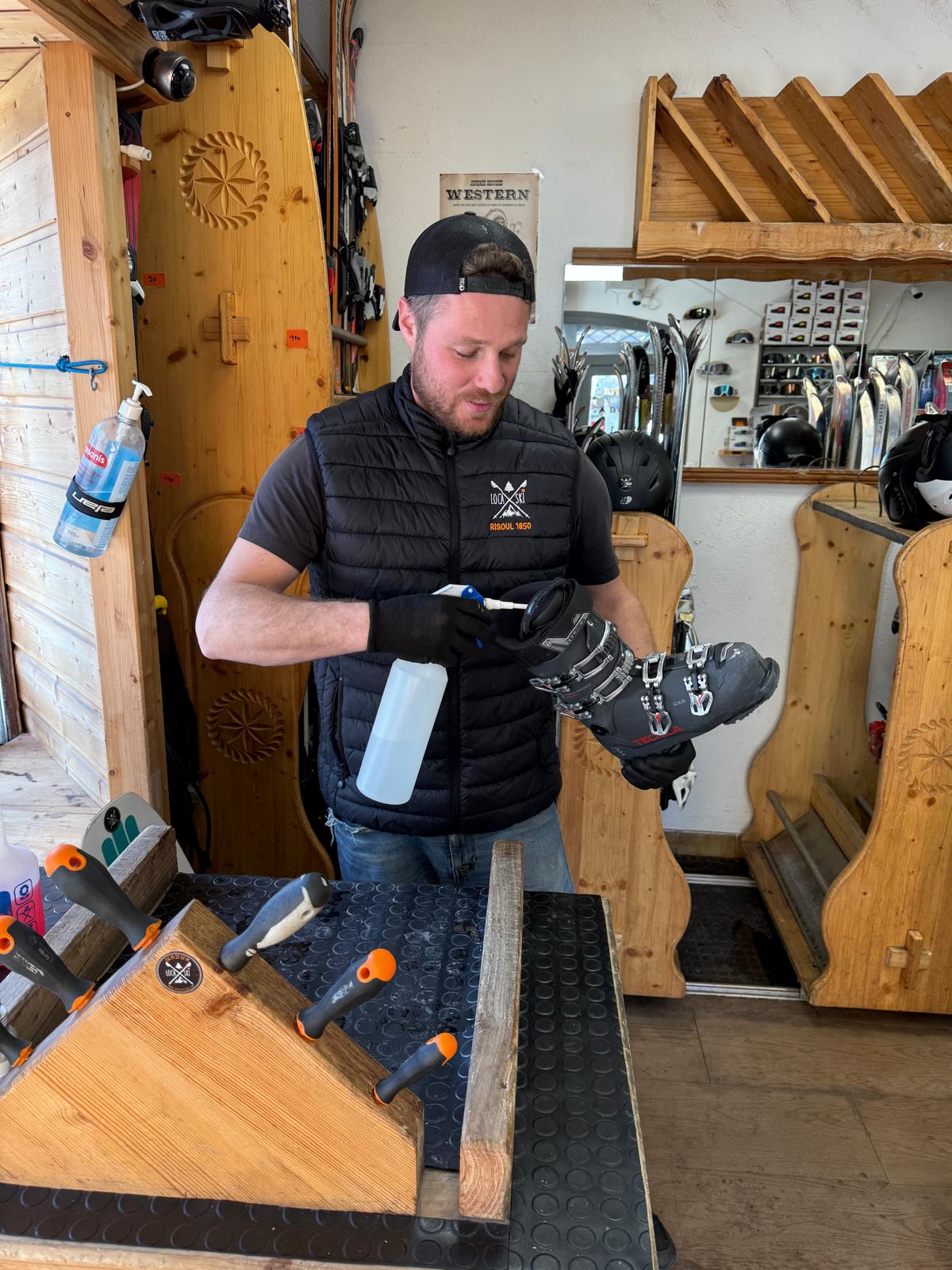 Loca’ski technician thoroughly disinfecting a ski boot