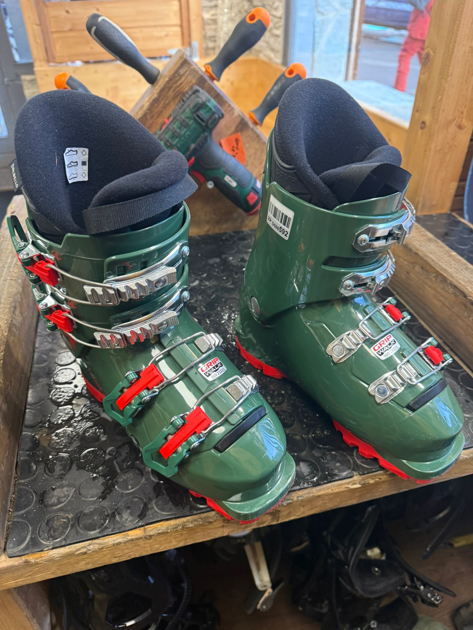 Comfortable Dalbello ski boots on a workshop workbench